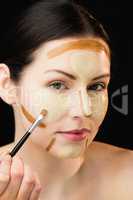 Woman doing contouring on her face