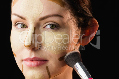 Woman doing contouring on her face