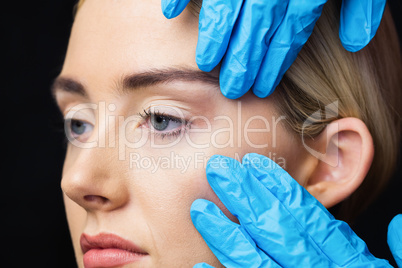 Woman has an examination of her skin before botox injection