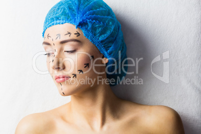 Peaceful young patient with dotted lines on the face