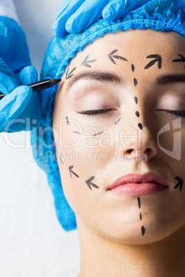 Peaceful young patient with dotted lines on the face