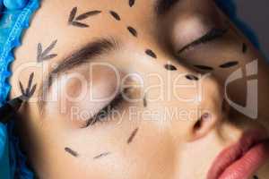 Peaceful young patient with dotted lines on the face