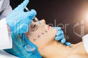 Woman receiving botox injection on her lips