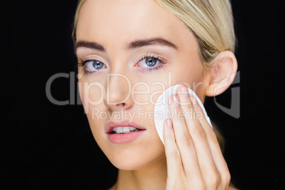 Beautiful woman putting makeup