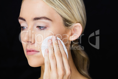 Beautiful woman putting makeup