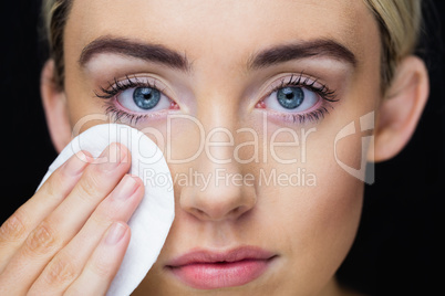 Beautiful woman putting makeup