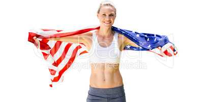 Portrait of smiling sportswoman posing with an american flag