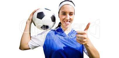 Portrait of happy woman football player holding a football