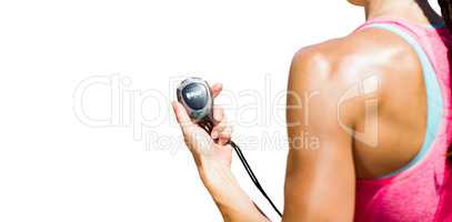 Close up on a sportswoman holding a timer