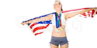 Portrait of happy sportswoman with medals holding american flag