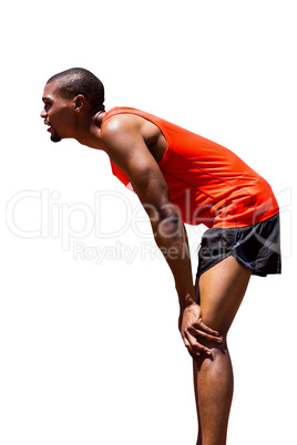 Profile view of sportsman posing his hands on knee