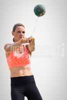Composite image of sportswoman throwing a hammer