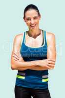 Composite image of sportswoman posing and smiling on a white bac