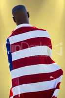 Composite image of rear view of man wearing american flag