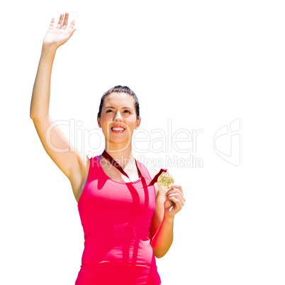 Athletic woman smiling and holding a medal