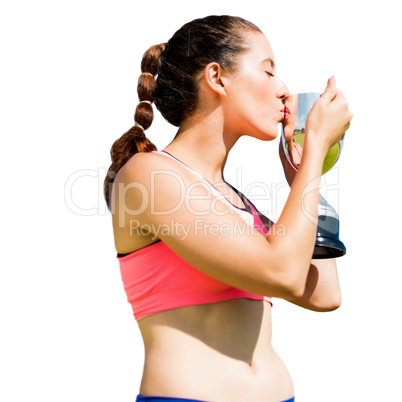 Sportswoman kissing her trophy