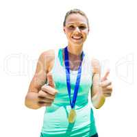 Portrait of smiling sportswoman holding a medal after a victory