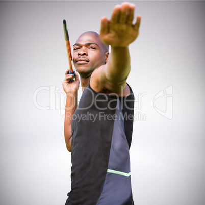 Composite image of portrait of sportsman practising a javelin th