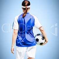 Composite image of rear view of woman soccer player holding a ba