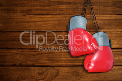 Composite image of boxing gloves attached to white background