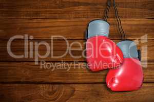 Composite image of boxing gloves attached to white background