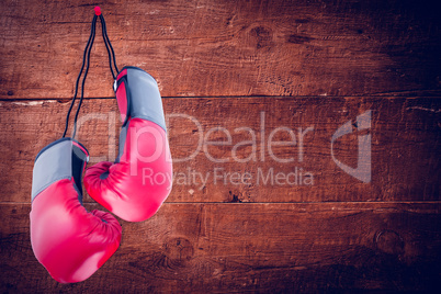 Composite image of boxing gloves attached to white background
