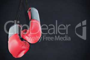 Composite image of boxing gloves attached to white background