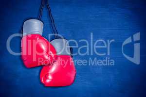 Composite image of boxing gloves attached to white background