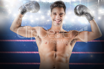 Composite image of portrait of happy boxer showing muscles