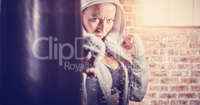 Composite image of portrait of female fighter in hood with fight