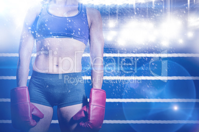 Composite image of midsection of female boxer with gloves