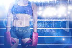 Composite image of midsection of female boxer with gloves