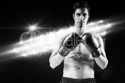 Composite image of portrait of boxer standing with boxing gloves