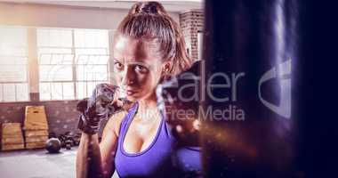 Composite image of portrait of female fighter punching