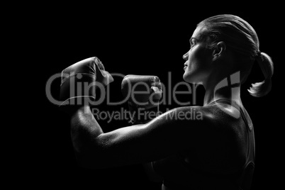 Composite image of side view of female boxer with fighting stanc
