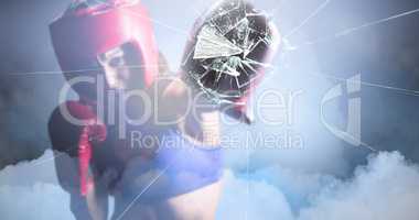 Composite image of female boxer with gloves and headgear punchin