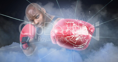 Composite image of fit man boxing with gloves