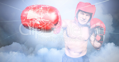 Composite image of boxer punching against black background