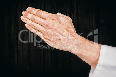 Composite image of karate player making hand gesture on white ba