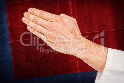Composite image of karate player making hand gesture on white ba