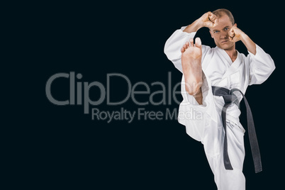 Composite image of fighter performing karate stance