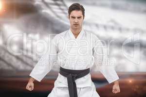 Composite image of portrait of serious karate player