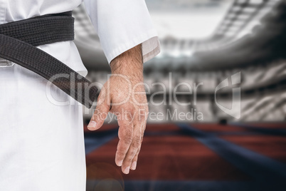 Composite image of close-up of karate black belt on white unifor
