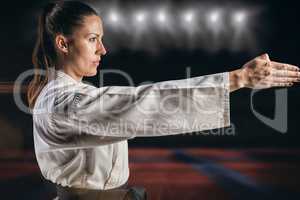 Composite image of female fighter performing karate stance