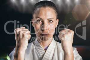 Composite image of female fighter performing karate stance