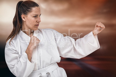 Composite image of fighter performing karate stance