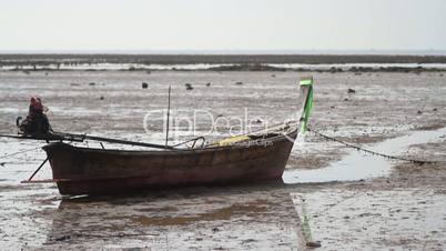 Wooden boat on the beach at low tide