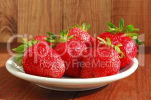 ripe red strawberries on the plate