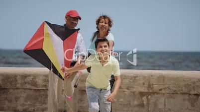 13-Family Boy And Grandparents Flying Kite Near Sea Slowmotion