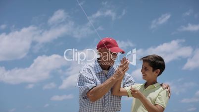 18-Family Grandpa Teaching Boy To Fly Kite Slowmotion